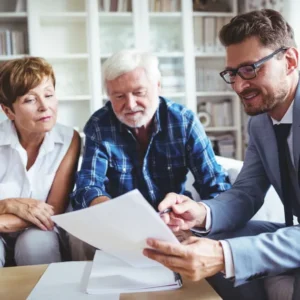 Man explaining a contract to an older couple